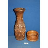 A slender Oak baluster vase, finely carved with vines and grapes (12" tall),