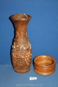A slender Oak baluster vase, finely carved with vines and grapes (12" tall),