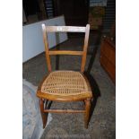 A cane seated Bedroom Chair of traditional design, stamped to the back "C.B.