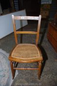 A cane seated Bedroom Chair of traditional design, stamped to the back "C.B.