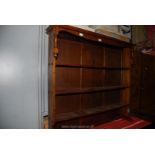 A dark Oak Bookshelves with upper turned details to the sides,