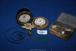 A box of vintage clock components.