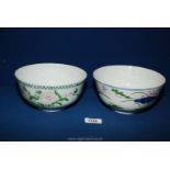 Two oriental bowls; one with painted pink flowers and green leaves, the other having green,