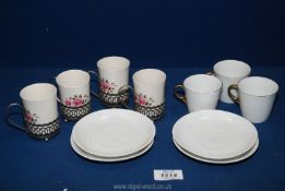 Four small coffee cans with plated handles by Wedgwood, plus four saucers and three cups,