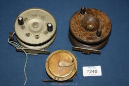 Two Victorian wooden fishing reels and one other.