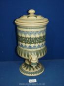 A Doulton Lambeth stoneware water filter/dispenser in urn shape with tap and lid having applied