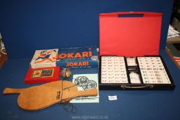 A cased Mah-jong game (modern) and a boxed Jokari game with two bats.