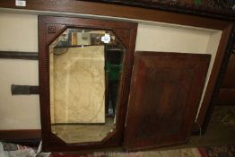 A bevel plated mirror with veneered frame, 28'' x 17 1/2'' overall and a wooden panel,