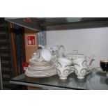 A part Susie Cooper 'Assyrian Motif' tea ware including; teapot, two cake plates,