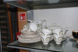 A part Susie Cooper 'Assyrian Motif' tea ware including; teapot, two cake plates,