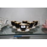 A set of six Royal Chelsea bone china cups & saucers in black with gilt rims.