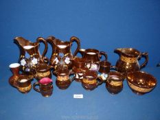 A quantity of lustre jugs including two large with yellow, white and blue flowers,