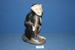 A novelty metal cast Monkey Money Box, 8'' tall. (screw missing).