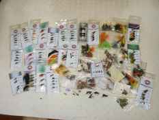 A box of approximately 50 packets of new fly fishing flies, with contents per pack between 4 and 40.