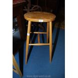 A Beech and other woods oval seated high Stool,