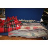 A red wool travel throw and a blue Aztec pattern rug a/f.