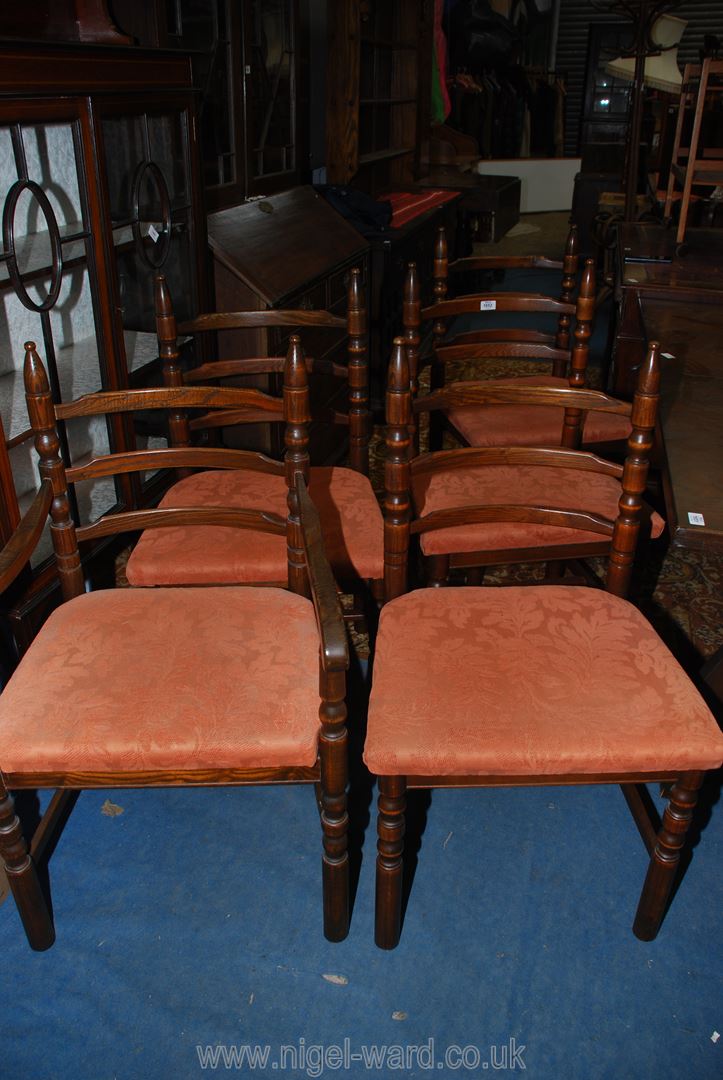 A set of five contemporary dark Oak framed Dining Chairs including one carver having turned legs,