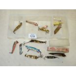 A Tackle Box and contents of Abu Toby spinners of varying ages including vintage one in box,