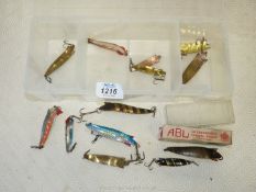 A Tackle Box and contents of Abu Toby spinners of varying ages including vintage one in box,