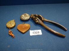 A pair of antique nut crackers with lions head and crown, white metal box and two lockets.