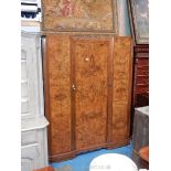 An attractive Mahogany carcassed Triple Wardrobe, the doors having cross-banded burr Walnut veneers,