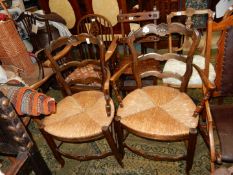 A pair of unusual seagrass seated open armed Carver Chairs having ladder backs and top rails with a