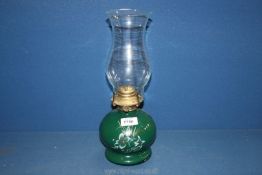 An oil Lamp with green ceramic base and glass chimney, 14" tall.