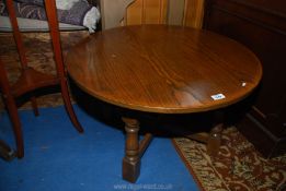 An Oak circular Table standing on turned legs with a cross stretcher, 30'' diameter x 18'' high.