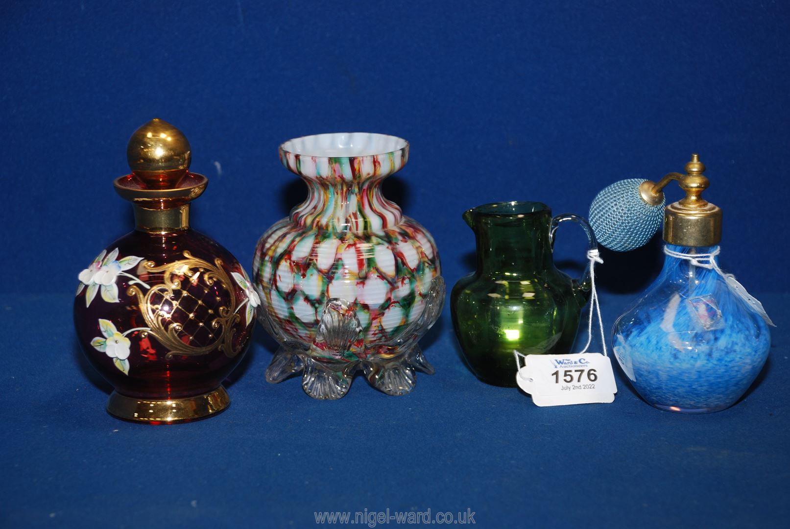 A cranberry coloured scent bottle with applied gilt and porcelain decoration,