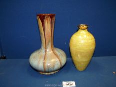 A Belgium pottery vase in brown and blue drip effect together with a thin tall yellow vase with