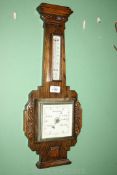 An Oak Barometer with carved detail to side, 23'' long overall.