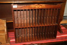 A darkwood letter rack with marquetry detail to top and sides,