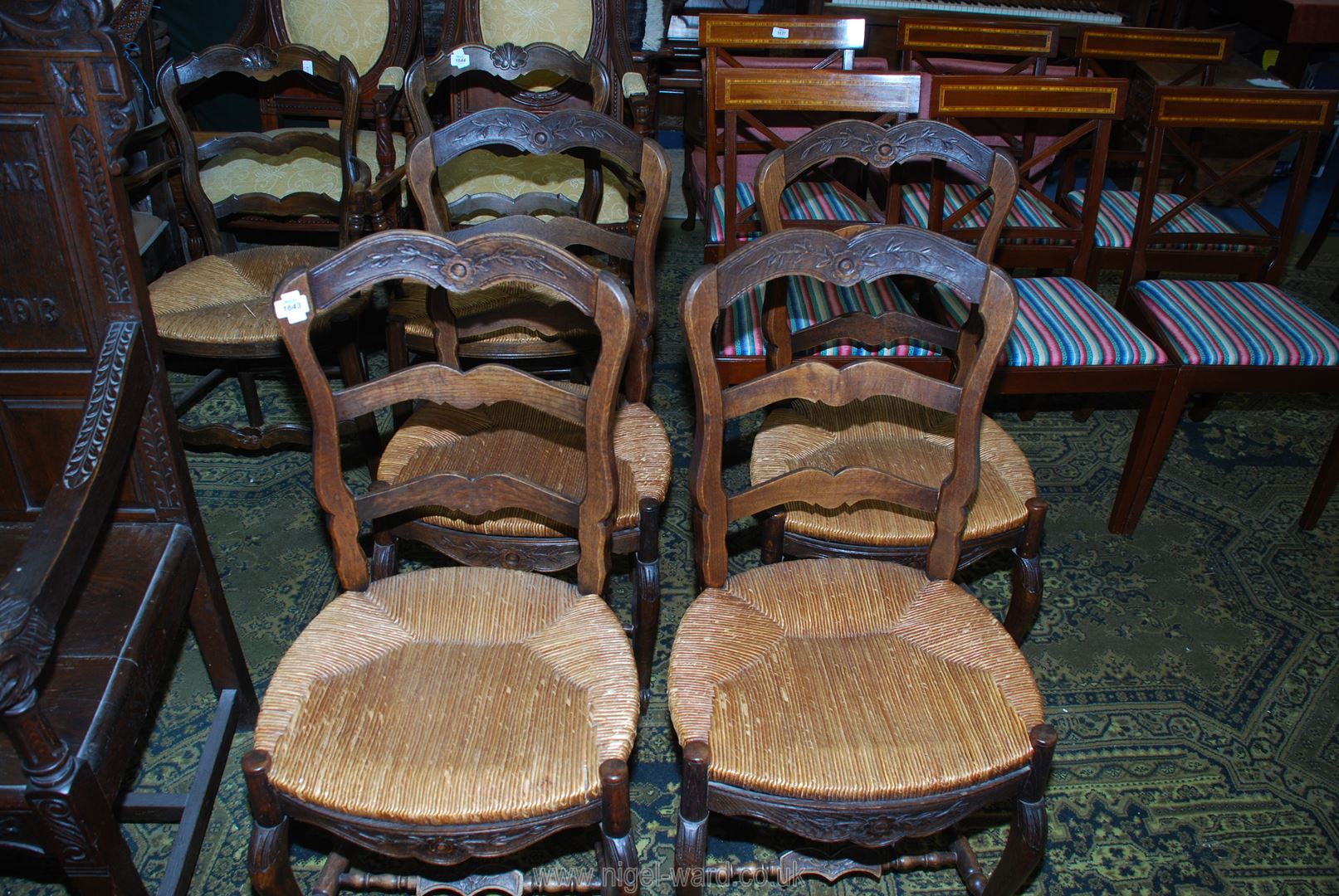 A set of four unusual seagrass seated Dining Chairs having ladder backs and carved top rail