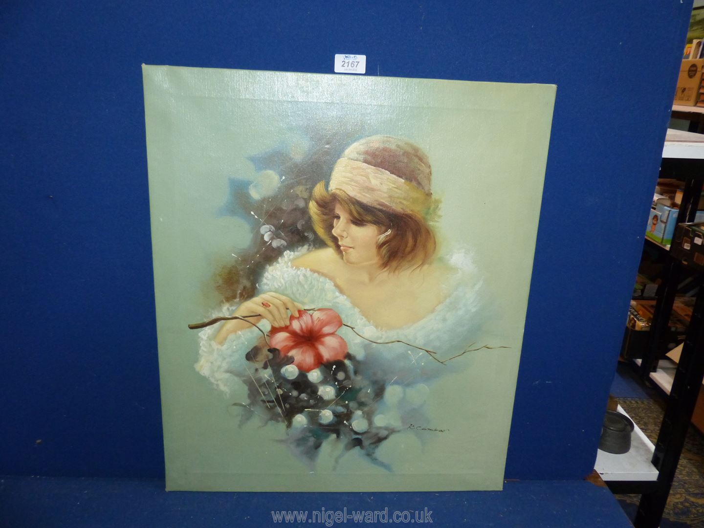 An unframed oil on canvas of a young lady with flowers, signed lower right K.