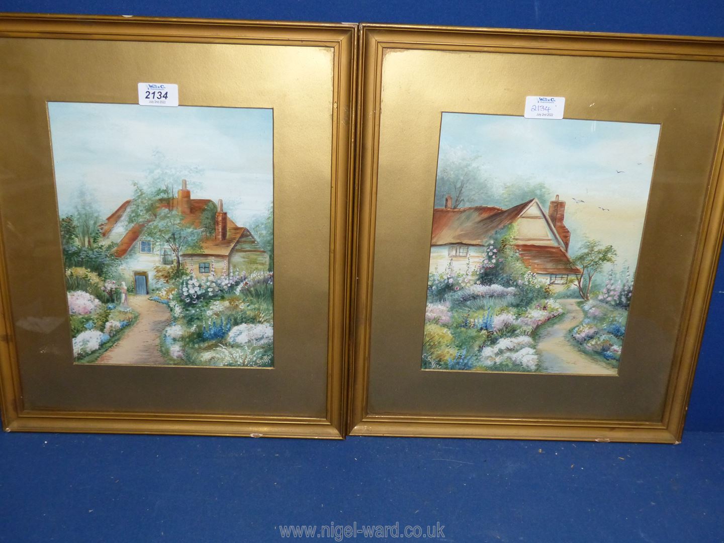A pair of gilt framed and mounted watercolours of Cottage Gardens, signed C.