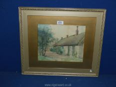 A framed and mounted watercolour depicting a cottage with chickens,