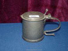 A vintage Commonwealth style Pewter Tankard with scroll handle and Charles medallion under the lid.