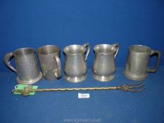 A quantity of pewter tankards and brass toasting fork.