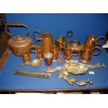 A quantity of copper and brass including measures, jugs, kettle, etc.