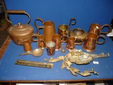 A quantity of copper and brass including measures, jugs, kettle, etc.