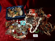 A quantity of jewellery including brooches, beaded necklaces, earrings, etc.