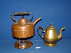 A brass teapot and a copper spirit kettle on trivet stand (missing burner).