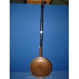 A copper Bed warming pan.