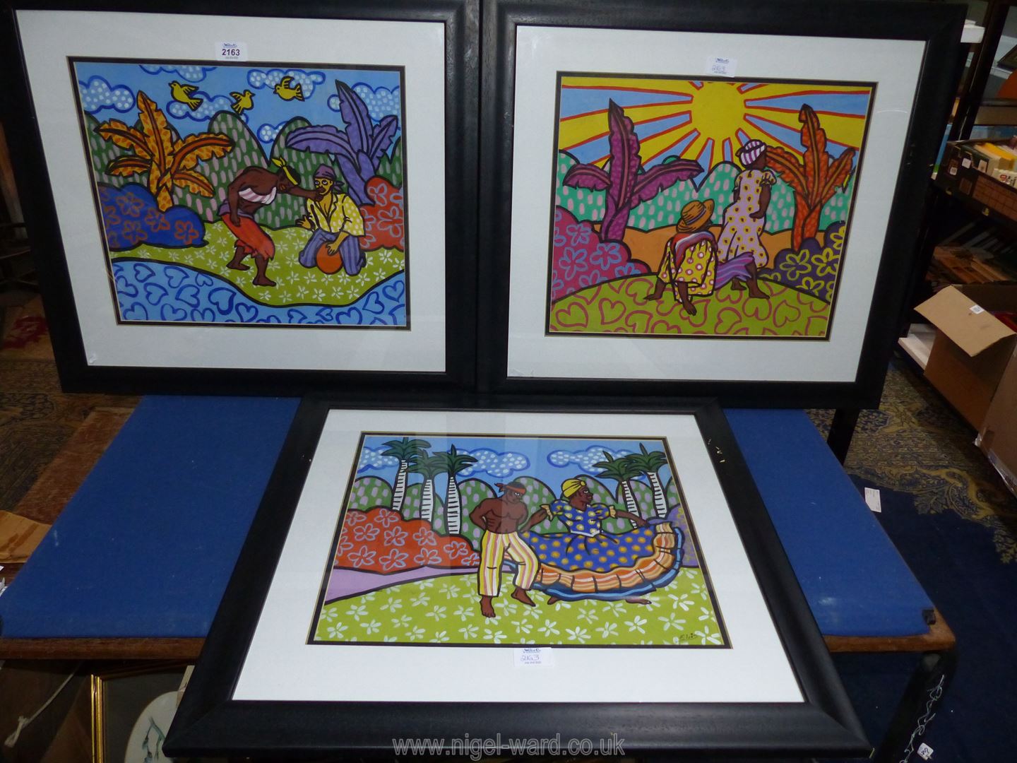 Three black framed Caribbean Watercolours of figures in landscapes, one signed Elvis,