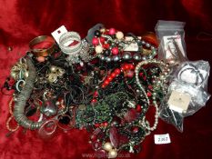 A quantity of jewellery including beaded necklaces and bracelets, bangles, loose beads, etc.