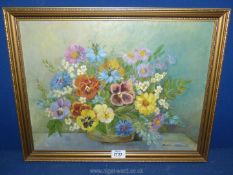 A framed Helen Mitchell oil on boards of a still life of flowers, signed lower right, 20'' x 16''.