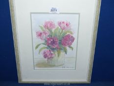 A framed and mounted ink wash depicting a still life vase of flowers, initialled lower right C.W 22.