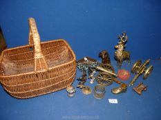 A basket of metalware including brass stag and brass cannons, etc.