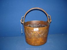 A hand hammered copper coal/log bucket, 11" wide x 10" high.