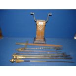 Three toasting forks, one being telescopic, four pokers with copper and iron stand.